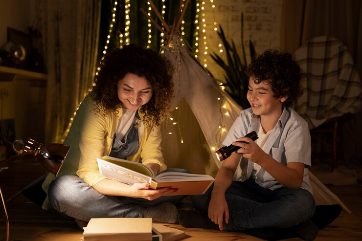 A child reading book with parent at night
