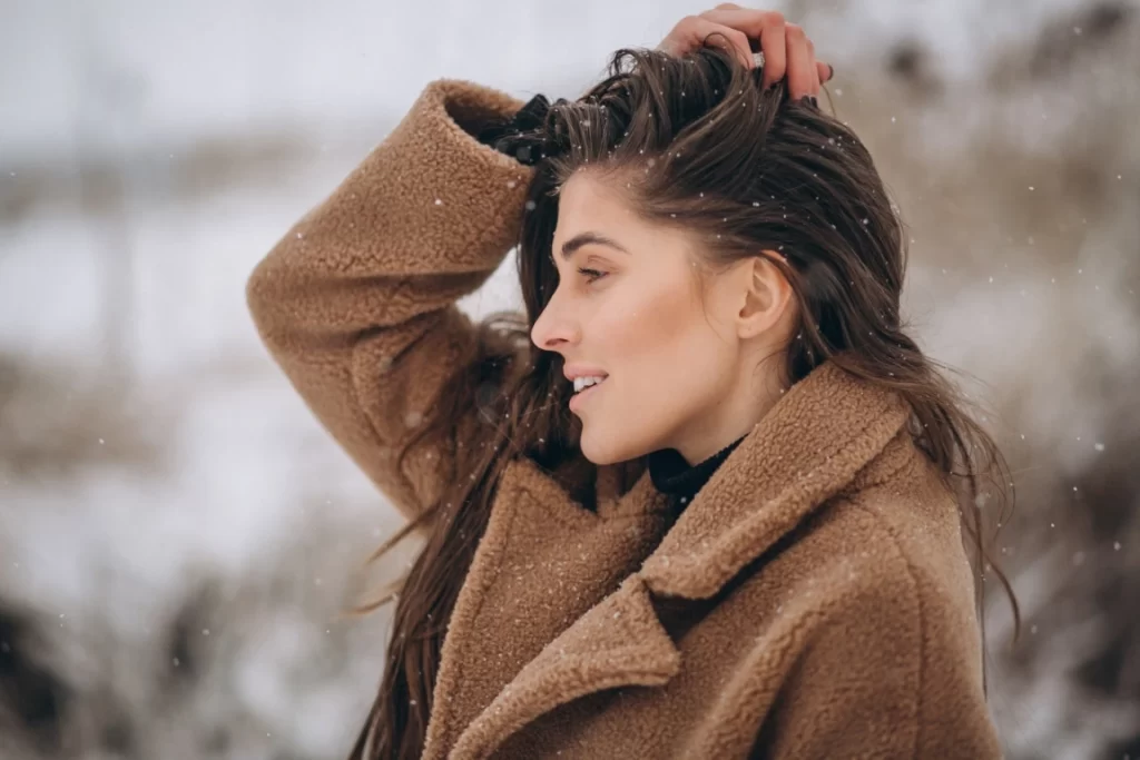 Portrait of women flaunting hair in snowflakes/winter